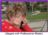 Woman with hands over eyes in anguish (Staged with professional model).